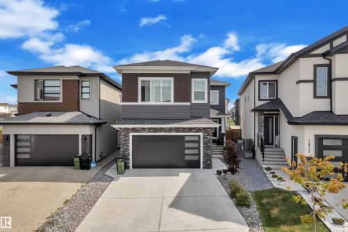 Contemporary home with a multi-textured facade including siding and stone accents - 1809 18A Avenue, Edmonton, AB - Outdoor With Facade