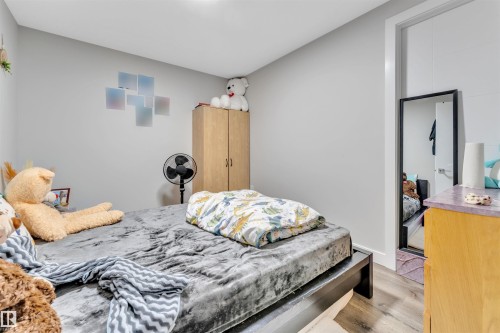 Light gray walls complementing wood-finish flooring - 1809 18A Avenue, Edmonton, AB - Indoor Photo Showing Bedroom