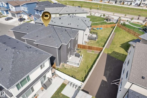 Modern residential property featuring a dark gray exterior, white trim, and a gray shingle roof - 1809 18A Avenue, Edmonton, AB - Outdoor