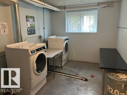 Dedicated laundry area featuring front-loading and top-loading appliances, a utility sink, and a window for natural light - 2 6920 101 Avenue Nw, Edmonton, AB - Indoor Photo Showing Laundry Room
