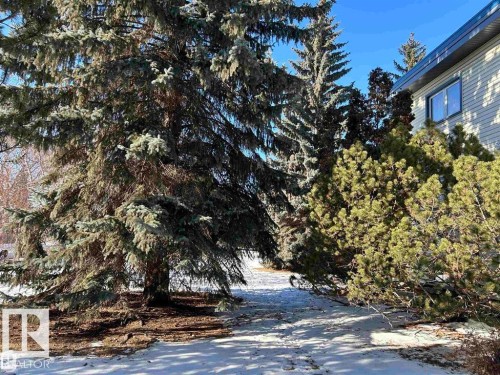 Property exterior with light-colored horizontal siding and dark trim - 2 6920 101 Avenue Nw, Edmonton, AB - Outdoor With View