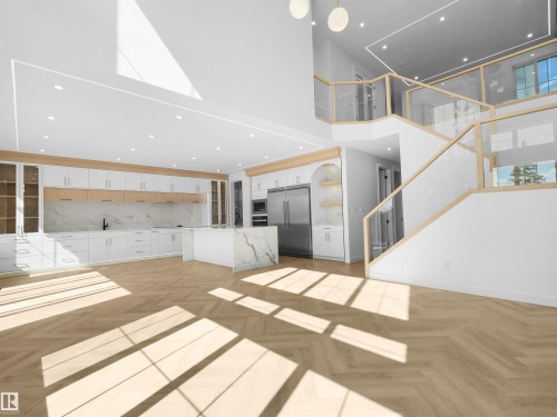 Open-concept interior featuring wood-finish herringbone flooring, a multi-level staircase with glass railings, a chef's kitchen with a waterfall island, and integrated stainless steel appliances - 2070 Collip Crescent, Edmonton, AB - Indoor Photo Showing Other Room