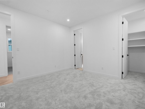 Neutral-toned wall-to-wall carpeting complements bright white walls and trim - 2070 Collip Crescent, Edmonton, AB - Indoor Photo Showing Other Room