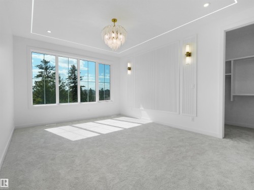 Bright primary bedroom with broad windows, light gray carpet, recessed lighting, and a decorative ceiling fixture - 2070 Collip Crescent, Edmonton, AB - Indoor