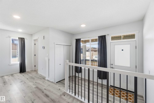 Entryway featuring wood-finish flooring, white walls, recessed lighting, and a white front door with a frosted glass panel - 22371 93 Avenue, Edmonton, AB - Indoor Photo Showing Other Room
