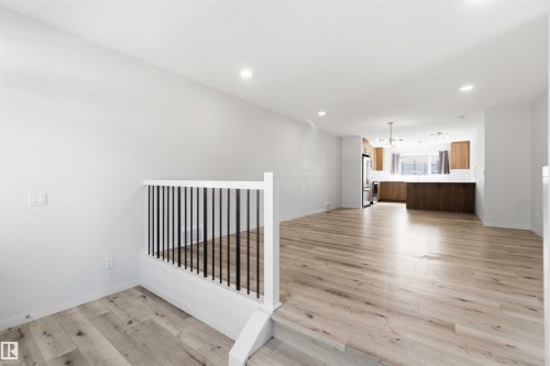 Open-concept living space featuring light wood-finish flooring and recessed lighting - 22371 93 Avenue, Edmonton, AB - Indoor Photo Showing Other Room
