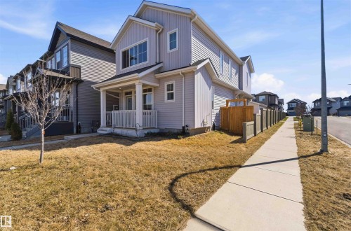 Light-colored siding exterior featuring a covered front porch with white railings and columns - 22371 93 Avenue, Edmonton, AB - Outdoor With Deck Patio Veranda