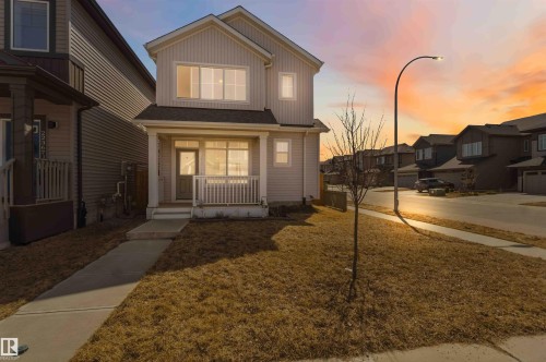 Two-story residential structure featuring light-toned siding and a covered front porch - 22371 93 Avenue, Edmonton, AB - Outdoor