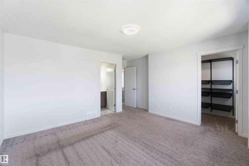 Spacious room featuring neutral carpeting and light-toned walls - 22371 93 Avenue, Edmonton, AB - Indoor