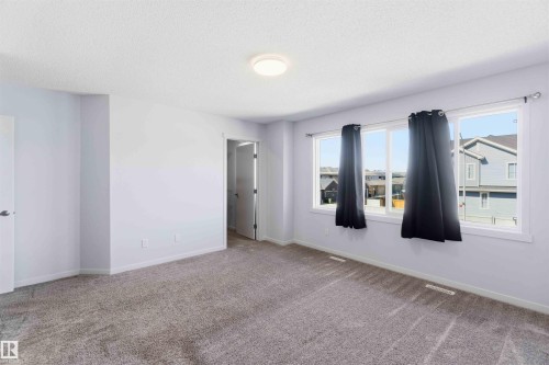 Spacious room featuring light gray walls, plush gray carpeting, and a flush-mount ceiling light - 22371 93 Avenue, Edmonton, AB - Indoor Photo Showing Other Room