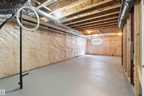 Spacious unfinished basement offering exposed ceiling joists, concrete flooring, insulation, and a built-in window well - 22371 93 Avenue, Edmonton, AB - Indoor Photo Showing Basement
