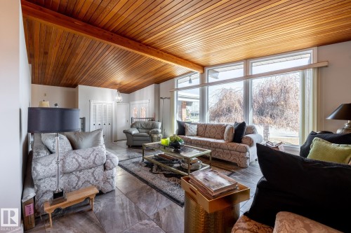 Vaulted wood-paneled ceiling with exposed beam - 16536 103 Street, Edmonton, AB - Indoor Photo Showing Living Room