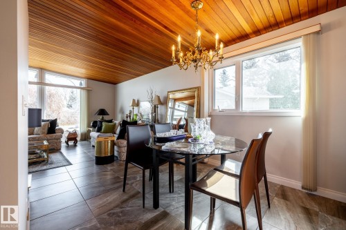 Dining area featuring a wood-finish vaulted ceiling and a brass chandelier - 16536 103 Street, Edmonton, AB - Indoor Photo Showing Dining Room