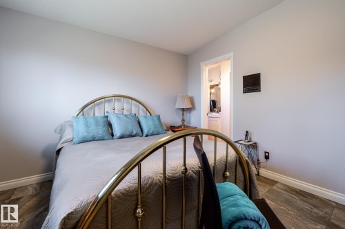 Bedroom featuring wood-finish flooring, light-toned walls, and white baseboards - 16536 103 Street, Edmonton, AB - Indoor Photo Showing Bedroom