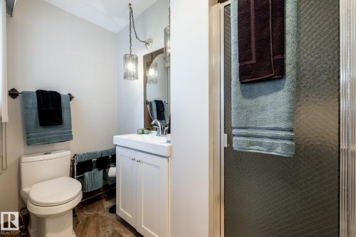 Bathroom featuring a white vanity with integrated sink, chrome faucet, and under-sink storage - 16536 103 Street, Edmonton, AB - Indoor Photo Showing Bathroom