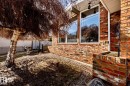 Brick exterior with large windows and a built-in brick planter - 16536 103 Street, Edmonton, AB  - Outdoor 