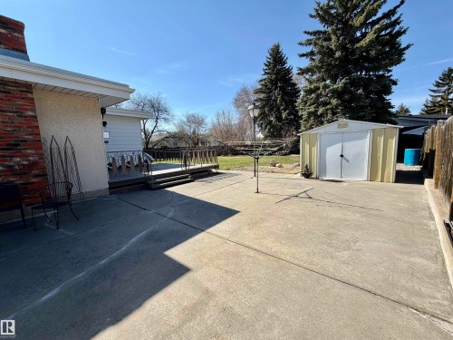 Expansive concrete patio with a raised wood deck - 16536 103 Street, Edmonton, AB - Outdoor