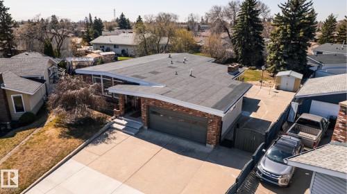 Mid-century modern residence featuring a flat roofline, brick facade, and an integrated two-car garage - 16536 103 Street, Edmonton, AB - Outdoor