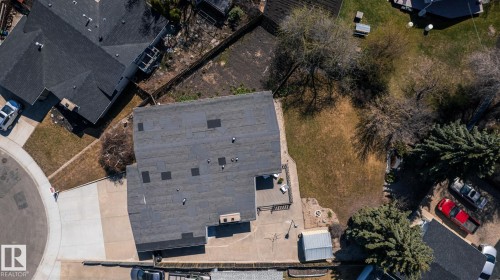 Overhead property view featuring a shingle roof, a rear deck, a concrete patio, a detached shed, and mature trees - 16536 103 Street, Edmonton, AB - Outdoor
