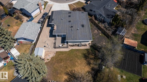 Aerial perspective showcasing a property with a spacious backyard, concrete patio, and mature trees - 16536 103 Street, Edmonton, AB - Outdoor With View