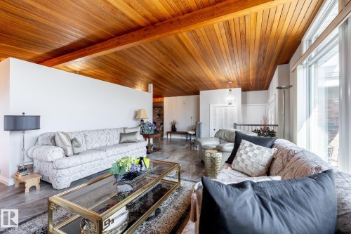 Vaulted wood-paneled ceiling with exposed wood beams - 16536 103 Street, Edmonton, AB - Indoor Photo Showing Living Room