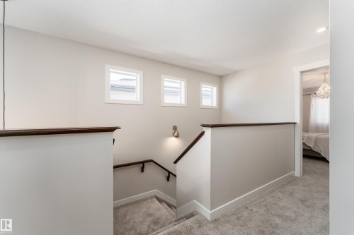 Upper-level landing with plush gray carpeting and white baseboards - 22064 95 Avenue, Edmonton, AB - Indoor Photo Showing Other Room