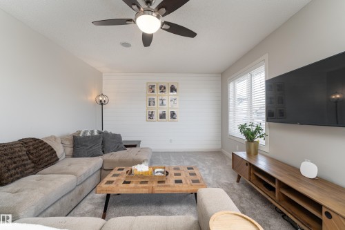 Living area featuring a ceiling fan, recessed lighting, and soft gray carpeting - 22064 95 Avenue, Edmonton, AB - Indoor Photo Showing Living Room