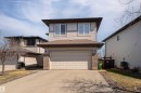 Two-story residence featuring light-colored siding and a two-car attached garage with a paved driveway - 22064 95 Avenue, Edmonton, AB  - Outdoor With Exterior 
