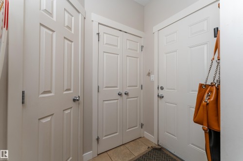 Entryway with white six-panel doors, neutral wall paint, and tile flooring - 22064 95 Avenue, Edmonton, AB - Indoor Photo Showing Other Room