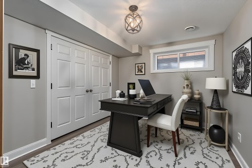 Dedicated room featuring wood-finish flooring, light gray wall paint, and white trim molding throughout - 22064 95 Avenue, Edmonton, AB - Indoor Photo Showing Office
