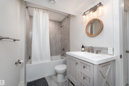 Bathroom featuring a light gray vanity with a white countertop and rectangular undermount sink - 22064 95 Avenue, Edmonton, AB - Indoor Photo Showing Bathroom
