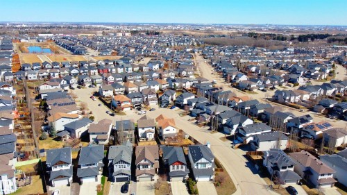 Aerial depiction of a residential development featuring numerous single-family homes with varying architectural styles and roof lines - 22064 95 Avenue, Edmonton, AB - Outdoor With View