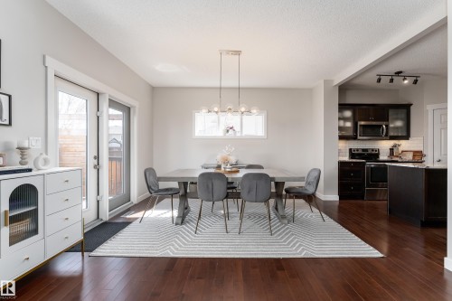 Open concept dining area with dark wood-finish flooring - 22064 95 Avenue, Edmonton, AB - Indoor Photo Showing Dining Room