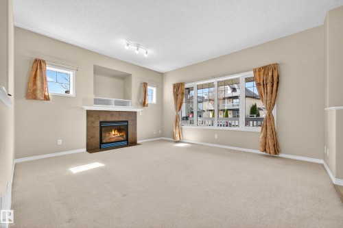 4989 Thibault Way, Edmonton, AB - Indoor Photo Showing Other Room With Fireplace