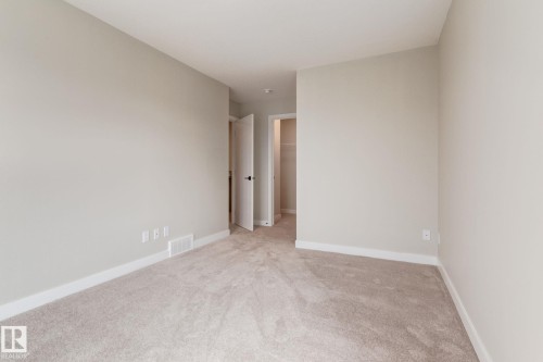 Neutral wall color with a light-toned carpet flooring - 44 16231 19 Avenue, Edmonton, AB - Indoor Photo Showing Other Room