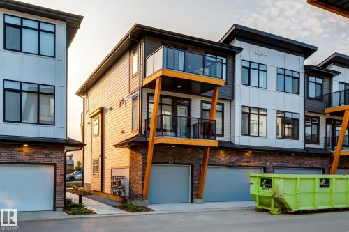 Contemporary townhouse exterior featuring a mix of brick, horizontal siding, and vertical paneling - 44 16231 19 Avenue, Edmonton, AB - Outdoor With Balcony
