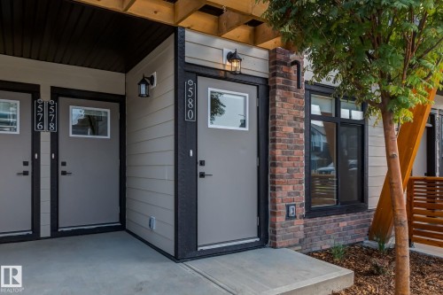 Modern exterior featuring horizontal siding, brick accents, and dark trim - 44 16231 19 Avenue, Edmonton, AB - Outdoor With Exterior