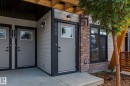 Modern exterior featuring horizontal siding, brick accents, and dark trim - 44 16231 19 Avenue, Edmonton, AB  - Outdoor With Exterior 