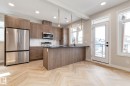 Kitchen featuring wood-finish cabinetry, stainless steel appliances, dark countertops, and a white subway tile backsplash - 44 16231 19 Avenue, Edmonton, AB  - Indoor Photo Showing Kitchen With Upgraded Kitchen 