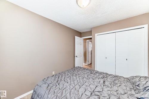 This room features light brown walls, a white ceiling, and a ceiling light fixture - 9813 152 Street, Edmonton, AB - Indoor Photo Showing Bedroom