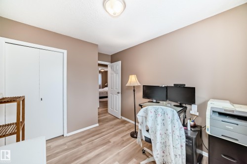 This room features warm-toned walls, light-colored flooring, and a white bi-fold closet - 9813 152 Street, Edmonton, AB - Indoor