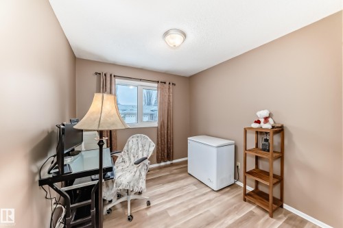 This room features light-toned flooring and a window with curtains, providing natural light - 9813 152 Street, Edmonton, AB - Indoor Photo Showing Office