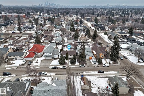 The property is situated within a residential neighborhood featuring established homes and mature trees - 9813 152 Street, Edmonton, AB - Outdoor With View