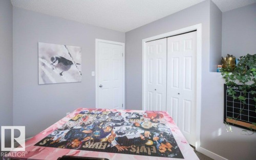 Light gray wall color with white trim and a white paneled door - 10812 109 Street, Westlock, AB - Indoor Photo Showing Bedroom