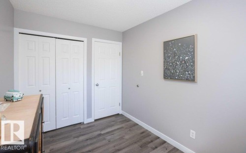 Two white bi-fold closet doors feature panel detailing - 10812 109 Street, Westlock, AB - Indoor