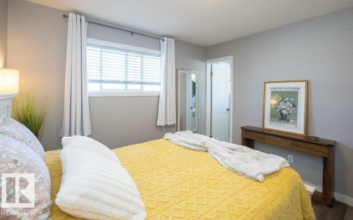 Interior room featuring light gray walls, a window with white blinds, and white trim - 10812 109 Street, Westlock, AB - Indoor Photo Showing Bedroom