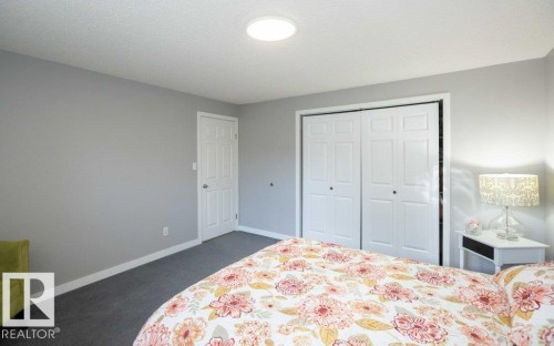 Gray wall tones complement dark gray carpeting - 10812 109 Street, Westlock, AB - Indoor Photo Showing Bedroom