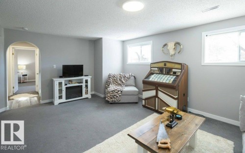 Spacious room featuring light gray wall paint and gray carpeting - 10812 109 Street, Westlock, AB - Indoor Photo Showing Living Room
