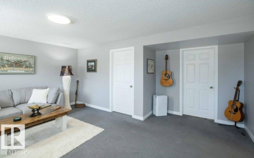 Interior space featuring gray carpeting, light gray walls, and white trim - 10812 109 Street, Westlock, AB - Indoor Photo Showing Other Room