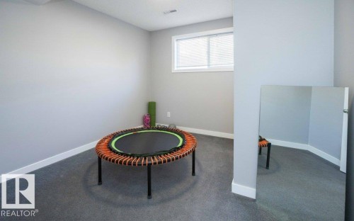Carpeted room featuring light gray walls, white baseboards, and a window - 10812 109 Street, Westlock, AB - Indoor Photo Showing Other Room